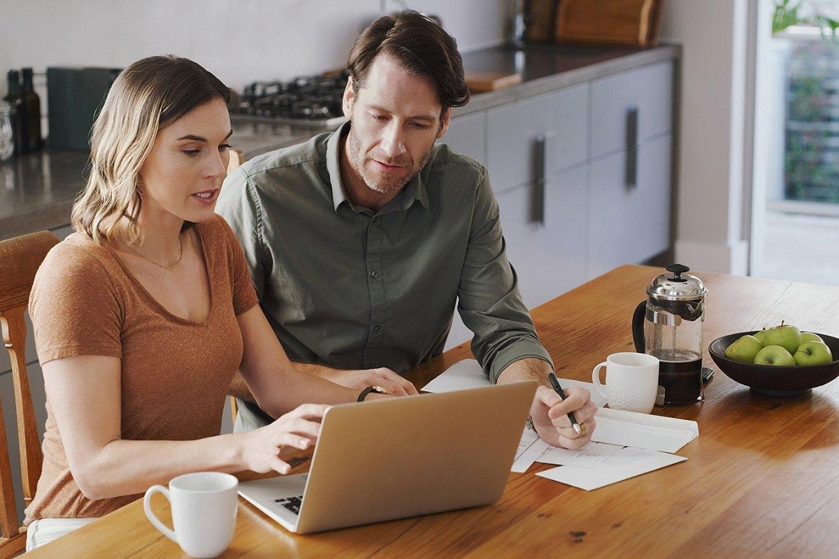 Couple reviewing finances on a laptop