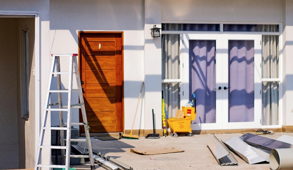 Home exterior with renovation materials and tools