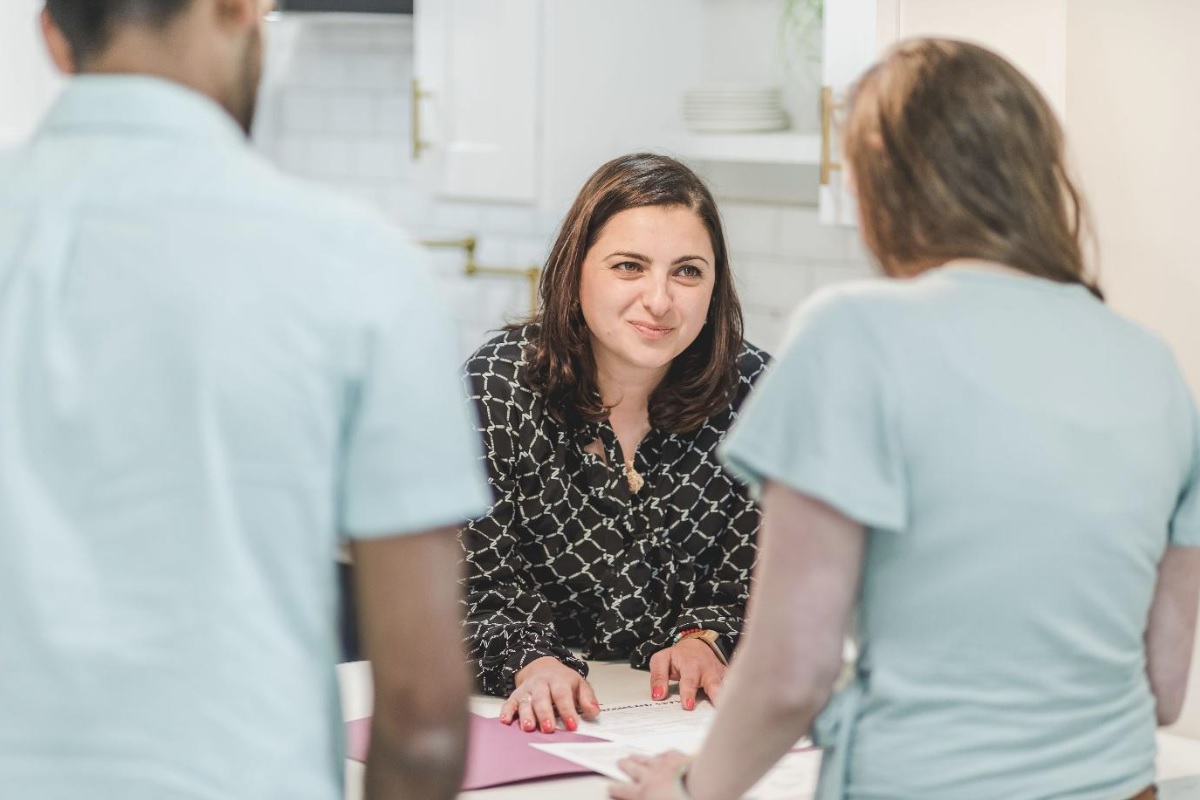 Mortgage broker discussing home loan options with a couple