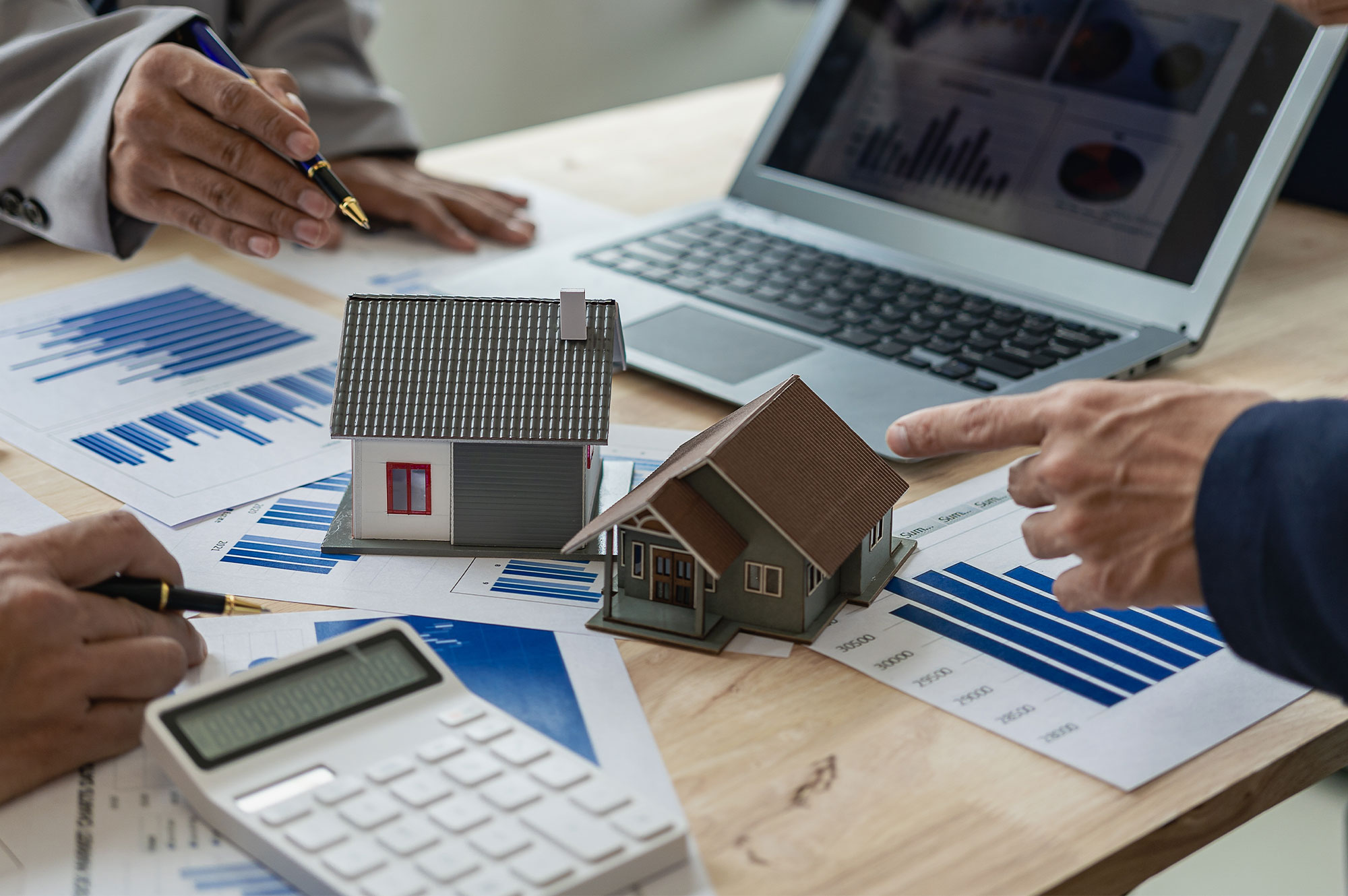 House models, financial charts and calculator representing growth in Australia’s housing loan market and property investment lending.
