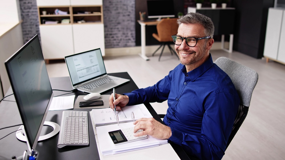 Buyers advocate reviewing property data and market research while helping clients purchase real estate in Australia.