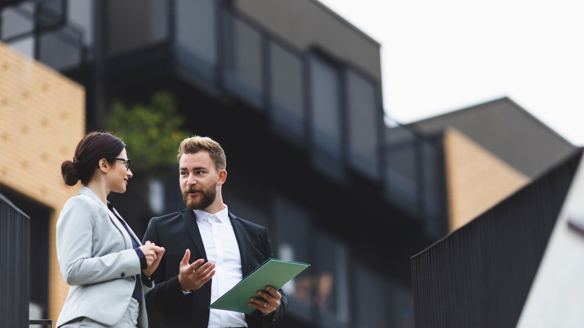 Property professionals discussing a property purchase representing buyer’s agent fees and services in Australia.