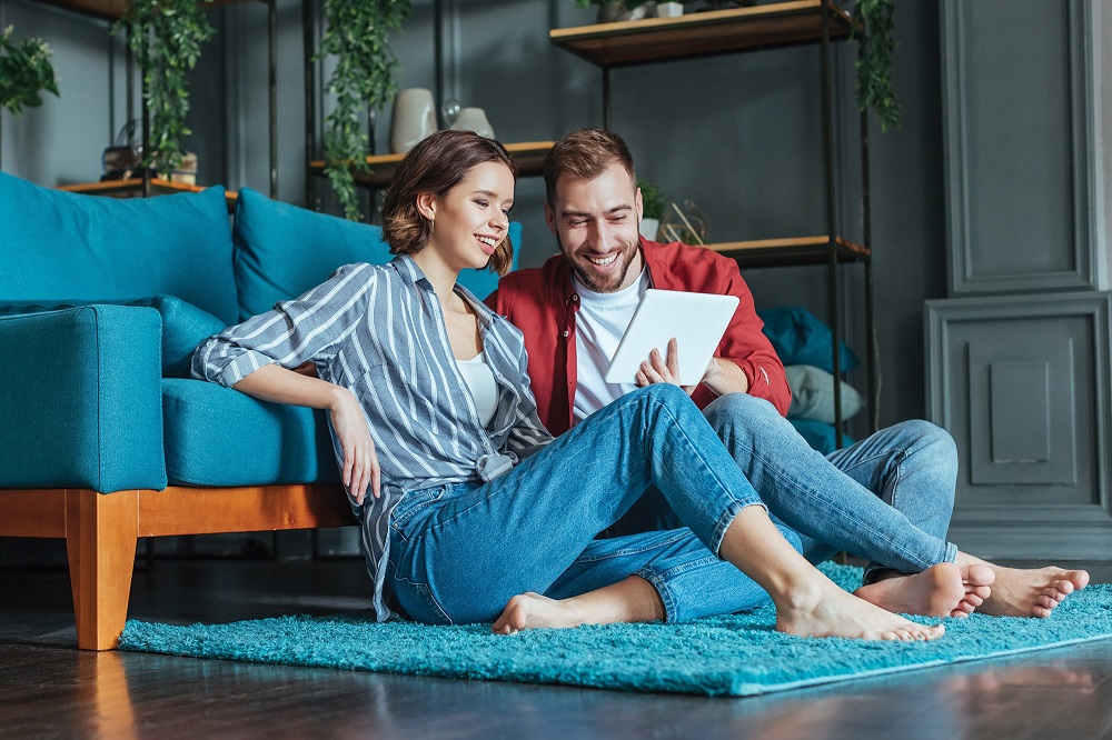 couple sitting on the floor in a living room