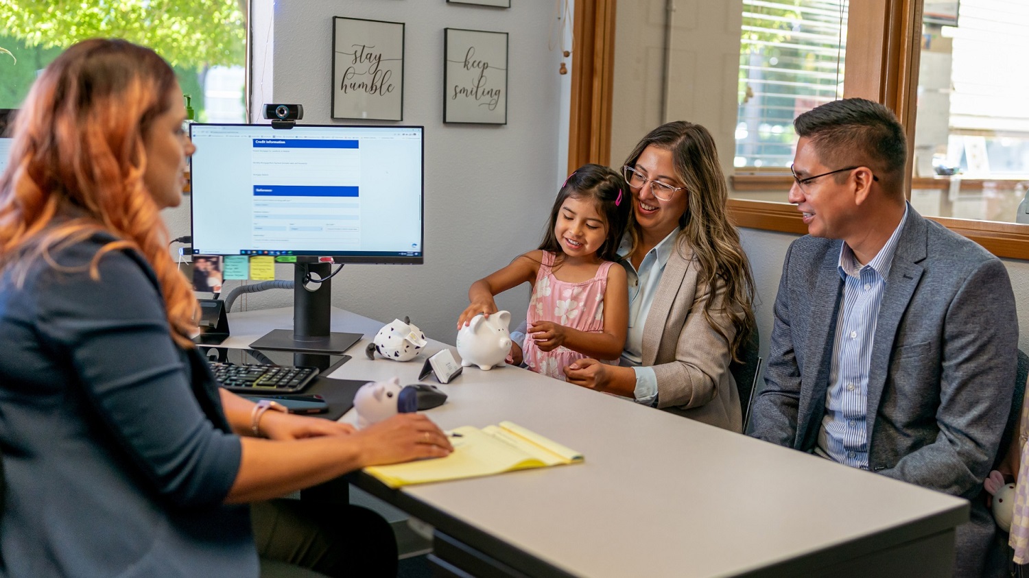 Family meeting with mortgage broker to discuss home loan features including offset accounts and redraw facilities.