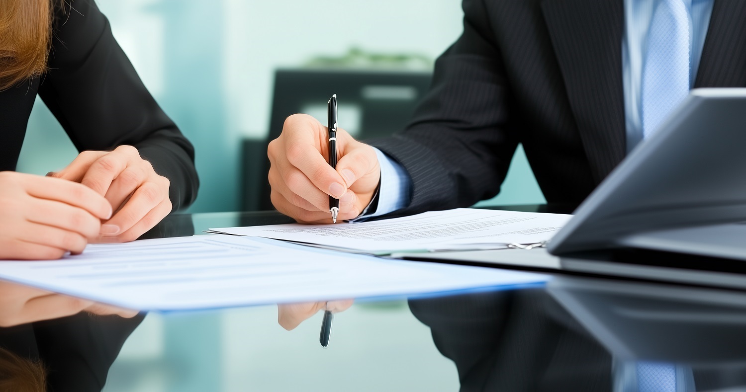 Signing documents during an investment property loan application in Australia.
