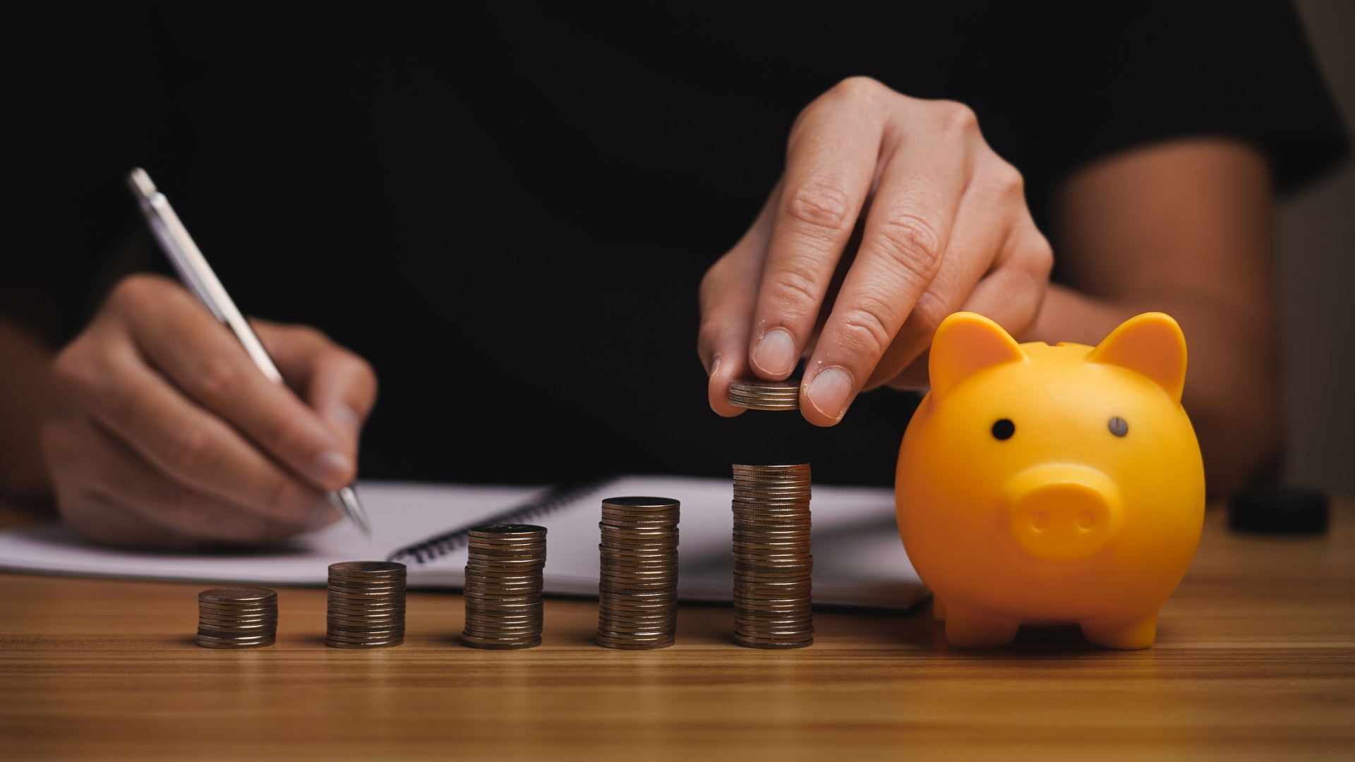 Savings and interest reduction concept showing coins and piggy bank for offset account home loan strategy.