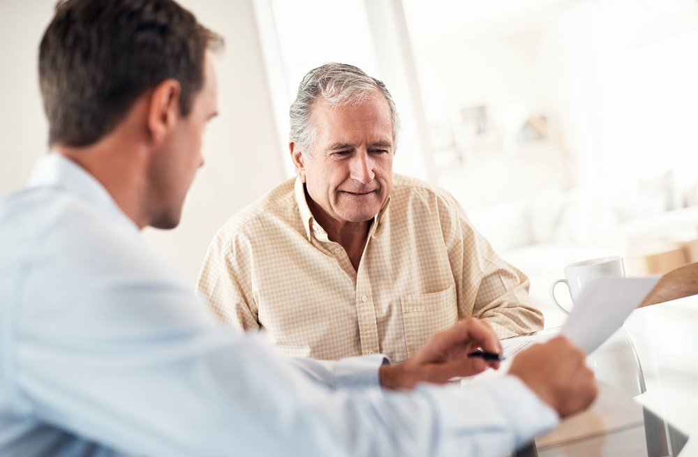 Property professional reviewing a strata report with a buyer before purchasing a strata property.