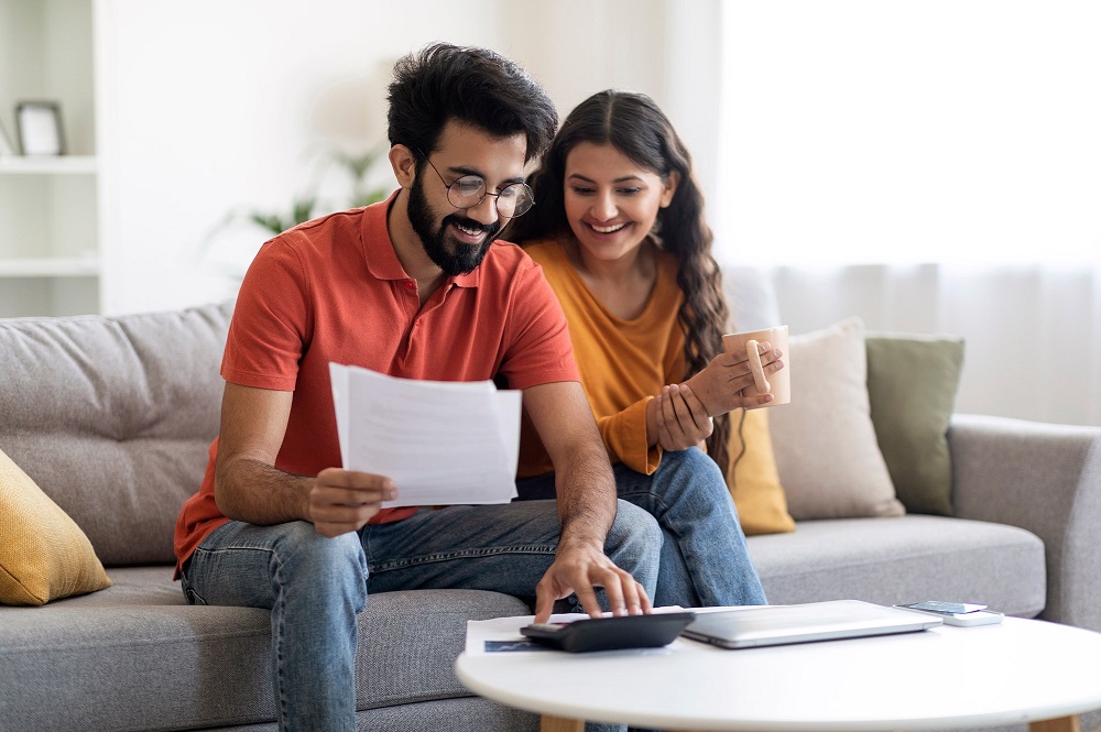 Self-employed couple reviewing income documents and calculating borrowing capacity for a home loan in Australia.