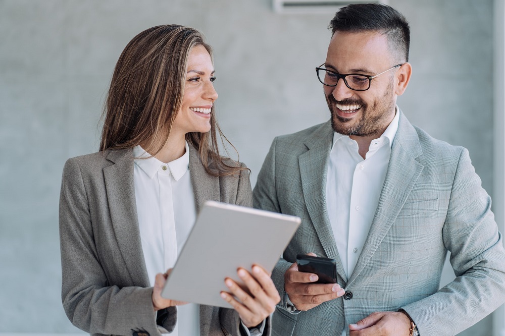 Real estate professionals reviewing a strata inspection report before purchasing a strata property.