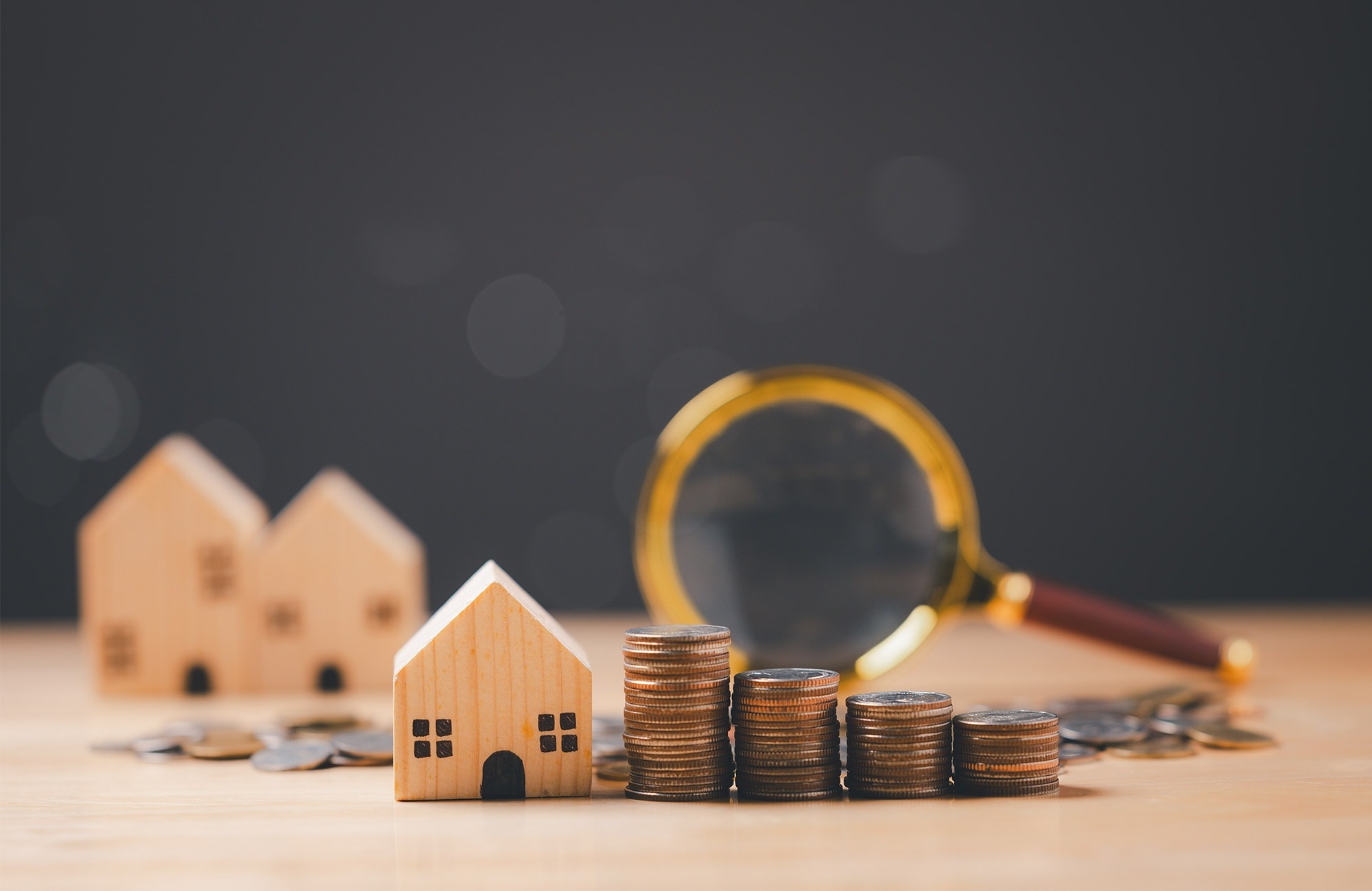 Sydney property market analysis concept with house model and stacked coins representing house price growth