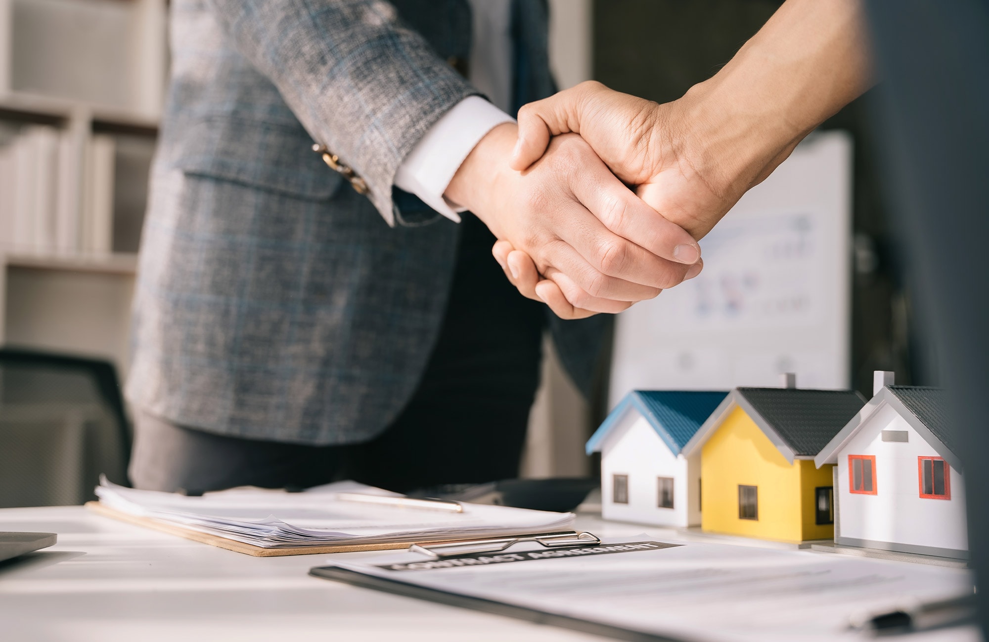 Property buyer shaking hands with broker after home loan approval for purchasing property in the Sydney housing market